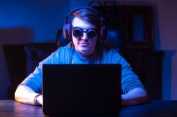 late night gamer with goggles on for blue light protection