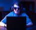 late night gamer with goggles on for blue light protection