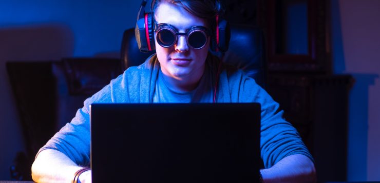 late night gamer with goggles on for blue light protection