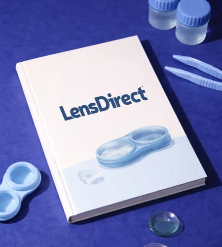 Contact lens case, tools, and LensDirect guidebook arranged on a blue surface for a complete contact lens overview.